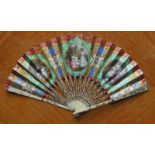 A paper and ivory hand fan. Ca. 1870-1880, likely made in France. The arms with metal inlay, the