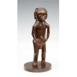 Gabon, Fang, standing male figure, ca. 1930; with hands resting on belly, small breast, thick neck
