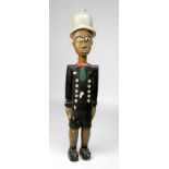 Ivory Coast, Baule, large standing colon figure, ca. 1930, in police uniform with helmet, a finely