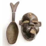 Ibibio, wooden mask and Dan, wooden spoon. mask painted in black with white accents. h. 23 and 42