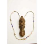 DRC., Pende, miniature wooden mask. with a sting of beads. h. 12 cm. [1]