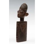 Yoruba, wooden doll, omo langidi, the square flat boddy with carved triangles and ridges on the