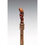 DRC., Yombe, fly whisk with ivory figure on top; the weathered wooden hilt with remnants of pigment,