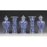 A Chinese blue and white garniture. One lid restored, one lid with flints, one vase with two