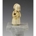 DRC., Luba, ivory pendant, in the form of a female figure with hands on the breasts, hair in a