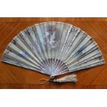 A mother of pearl hand fan. Painted scene of an angel with child, signed Andreas. Provenance: from a