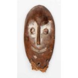 DRC., Lega, lukwakongo mask, oval mask with broad and curved mouth, kauri shaped eyes, remnants of