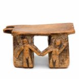 West Africa, wooden stool, decorated with two figures joined by hands in high relief on two of the