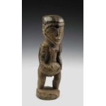 DRC., Kusu, standing female figure, robust carved standing figure with dark-grey encrusted patina.