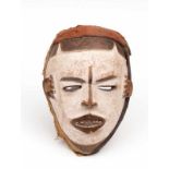 Nigeria, Idoma, wooden mask with black painted accents on a white ground. h. 24 cm. [1]