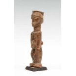 Burkina Faso, Lobi, bateba; standing male figure wearing a hat. With encrusted patina. Provenance,