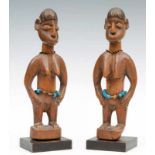 Benin, Fon, two twin figures, with broad shoulders, curved arms, hands on hips, strings of beads and