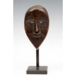 Ivory Coast, Dan, face mask, with pointed chin, small carved eyes and open mouth with protruding