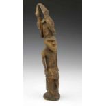 PNG, Sepik, wooden figure with two carved birds on conical head. Body with carved geometrical