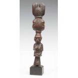 Nigeria, Yoruba, Shango staff, a carved seated female figure on top on conical short shaft and