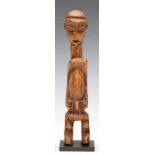 DRC., Luntu, standing male figure with faceted face, pointed chin, protruding shoulders, curved arms