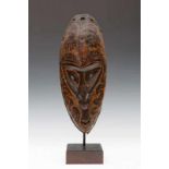 PNG, Sepik, mask, with pointed chin, small V-shaped mouth, small nose with open septum, oval eyes.