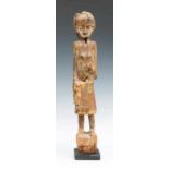 Borneo, Kalimantan, hampatong; in the form of a standing female figure with a skirt, a bag in the