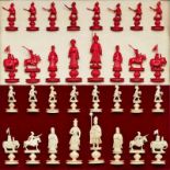 Schachfiguren, China/ Macau um 1900. Elfenbein, vollrd.geschnitzt, hälftig rot gefärbt. Fein