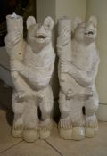 A pair of carved and white painted wood models of bears