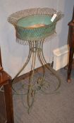 A French wirework planter, painted in green, 91cm high