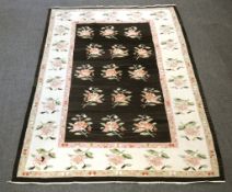A modern Tricana Rug, woven in shades of pink, green, and cream