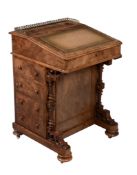 A Victorian walnut Davenport, one side with bank of four drawers