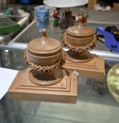 A pair of carved pine bookends modelled with swagged urns, 20th century