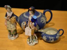 A pair of late 19th century porcelain models of a man and a woman A pair of late 19th century