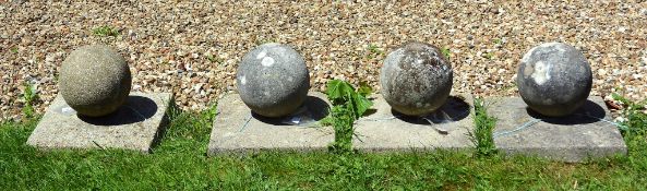A set of four stone composition garden sphere finials, 20th century