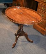 A mahogany oval side table with piecrust edge, 68cm wide overall