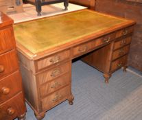 A mahogany kneehole desk, 20th century , with faux green leather inset top