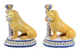 Two French faience models of lions, 25cm high