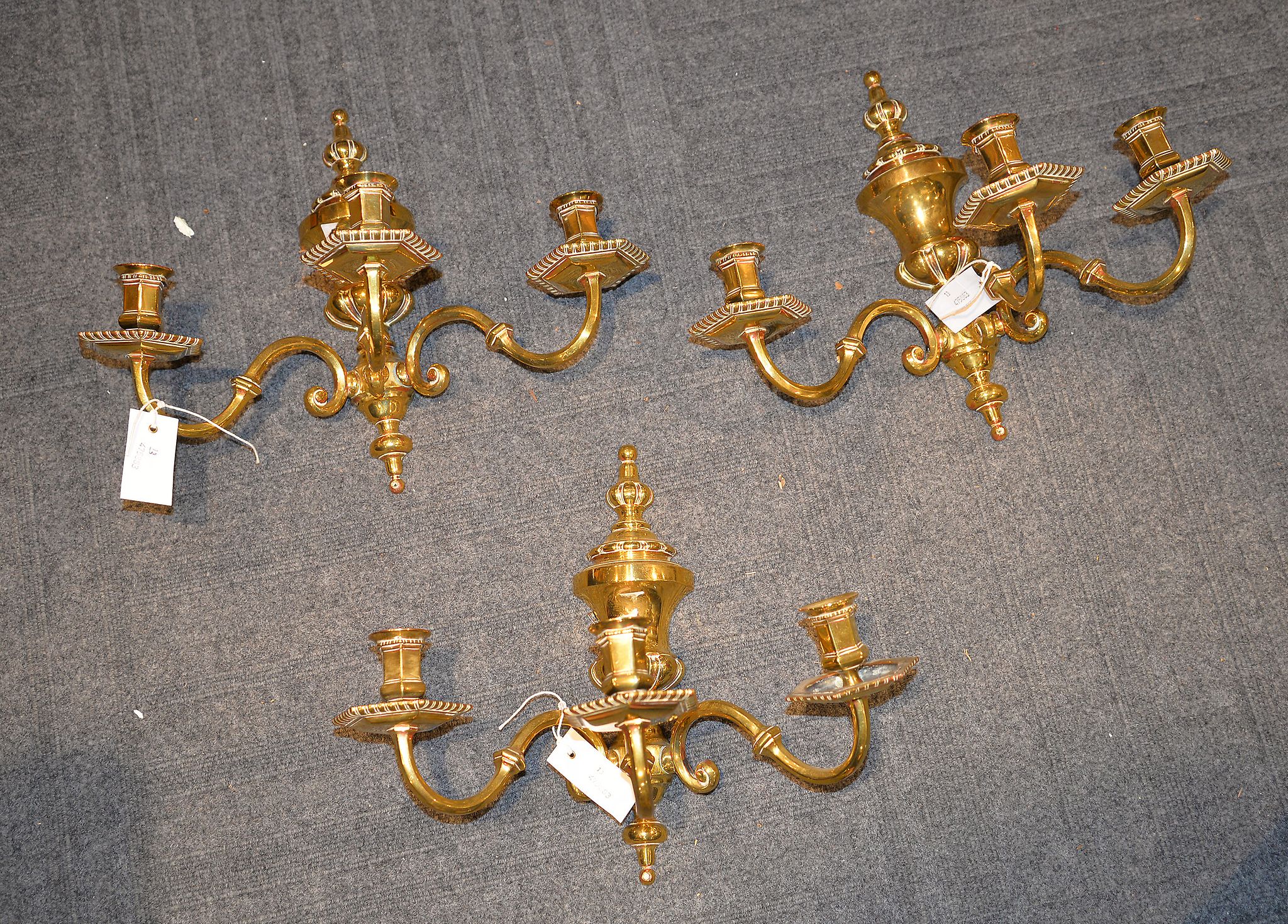 A set of three brass three light wall appliques, 20th century, 33cm high