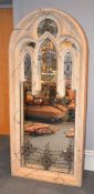 A composition stone mirror in Gothic Revival taste, on a metal base