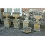 A set of four stone composition urns on plinths, 20th century, 82cm high overall