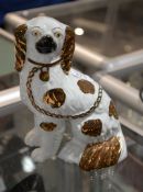 A Staffordshire pottery spaniel, decorated in copper lustre