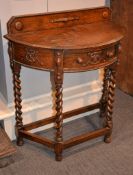 An oak bow fronted hall table, 76cm wide