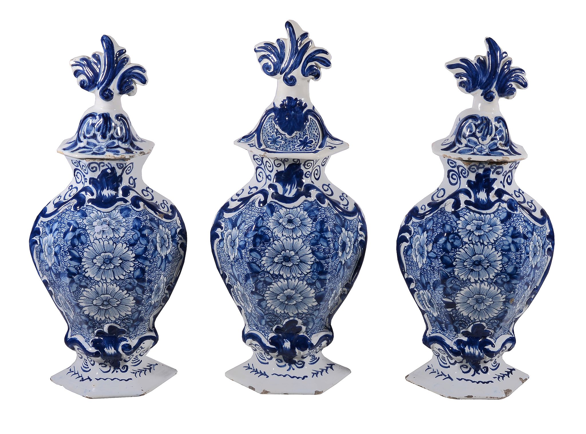 A garniture of three Dutch Delft blue and white hexagonal section vases and... A garniture of