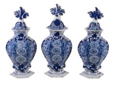 A garniture of three Dutch Delft blue and white hexagonal section vases and... A garniture of