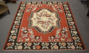 A modern Tricana rug, decorated with a central shaped cream panel