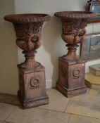 A pair of terracotta garden urns on pedestals, second half 20th century