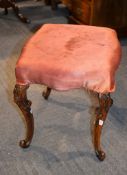 A Victorian carved walnut and upholstered stool in rococo revival style