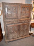 A carved oak two part aumbry cupboard, later 17th century, 184cm high