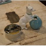 An English porcelain model of a terrier with a ball of wool; and a pot lid