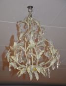 A pale green painted metal chandelier, hung with faceted drops
