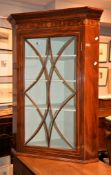 A George III mahogany and inlaid hanging corner cupboard, circa 1790