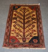 A rug with tree of life design, approximately 182cm x 116cm