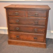 An Edwardian walnut chest of drawers, with two short and three long