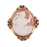 A Victorian shell cameo brooch, circa 1880, the oval panel carved with the relief of Diana with bow
